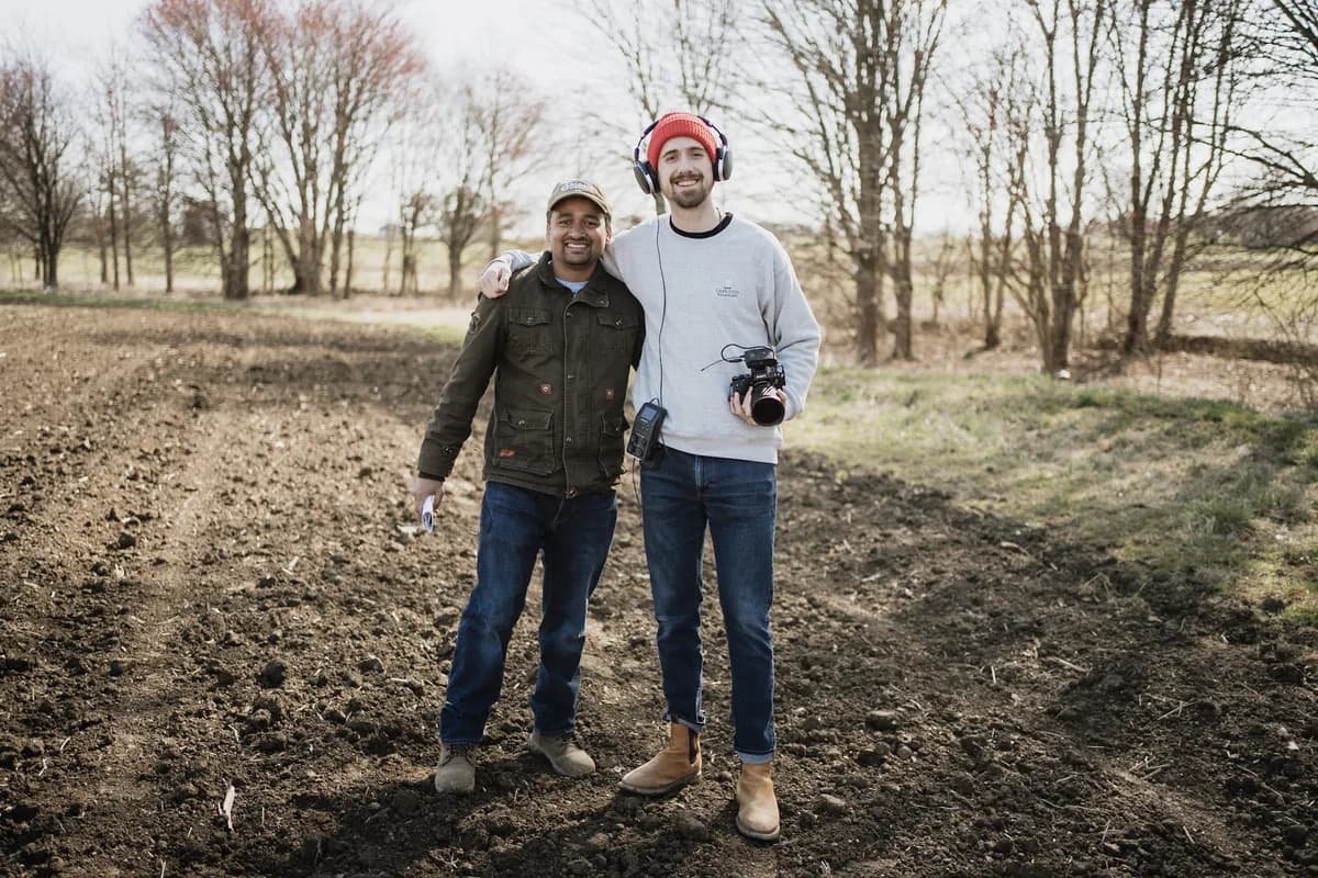 Jack Dempsey with a customer in a cultivated field
